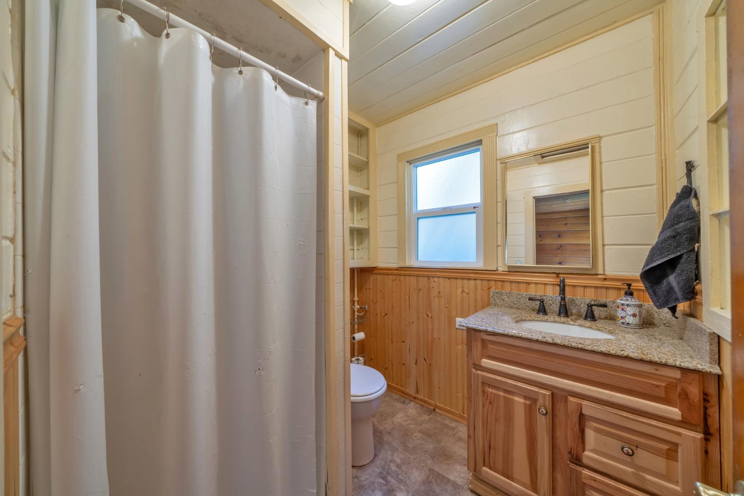 6929 Split Bend Road Pollock Pines, CA 95726 - Photo 19 of 38 a bathroom with a granite countertop sink and a mirror