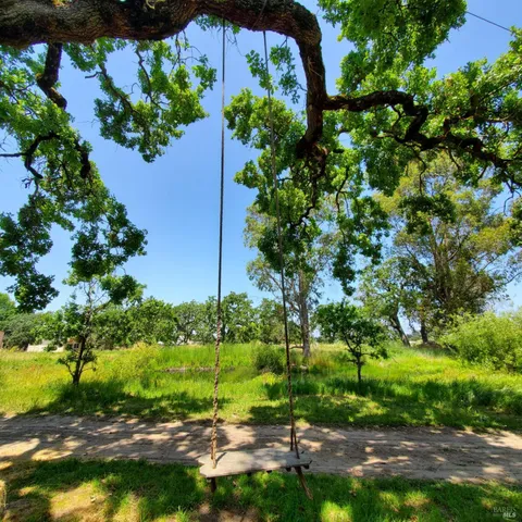 a view of a house with a yard and mountain view