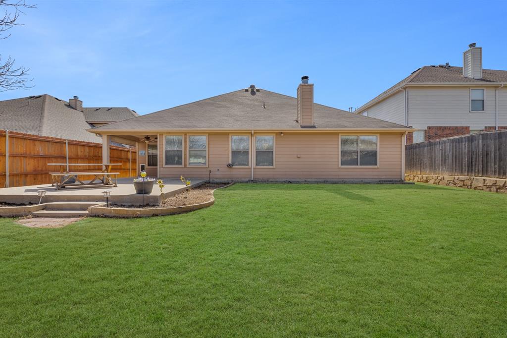 5129 Leeray Road Fort Worth, TX 76244 - Photo 18 of 39 a view of a house with a backyard and a patio