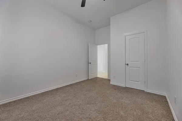 a kitchen with white cabinets and appliances