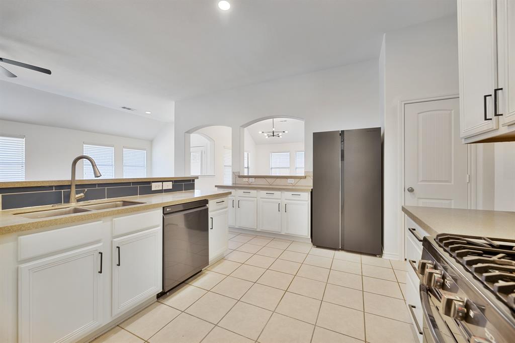 5129 Leeray Road Fort Worth, TX 76244 - Photo 29 of 39 a kitchen with a sink a stove and refrigerator