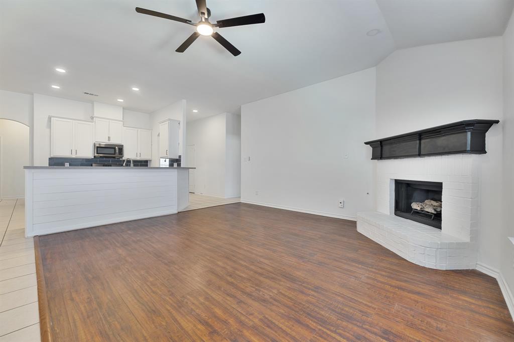 5129 Leeray Road Fort Worth, TX 76244 - Photo 32 of 39 a view of a kitchen with a sink and a fireplace