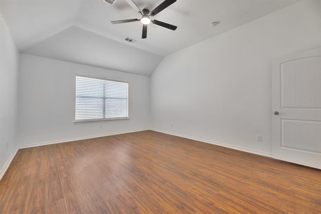5129 Leeray Road Fort Worth, TX 76244 - Photo 38 of 39 an empty room with wooden floor chandelier fan and windows