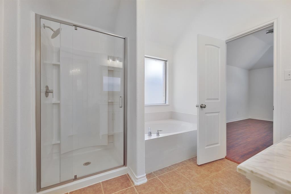 5129 Leeray Road Fort Worth, TX 76244 - Photo 39 of 39 a bathroom with a bathtub and shower