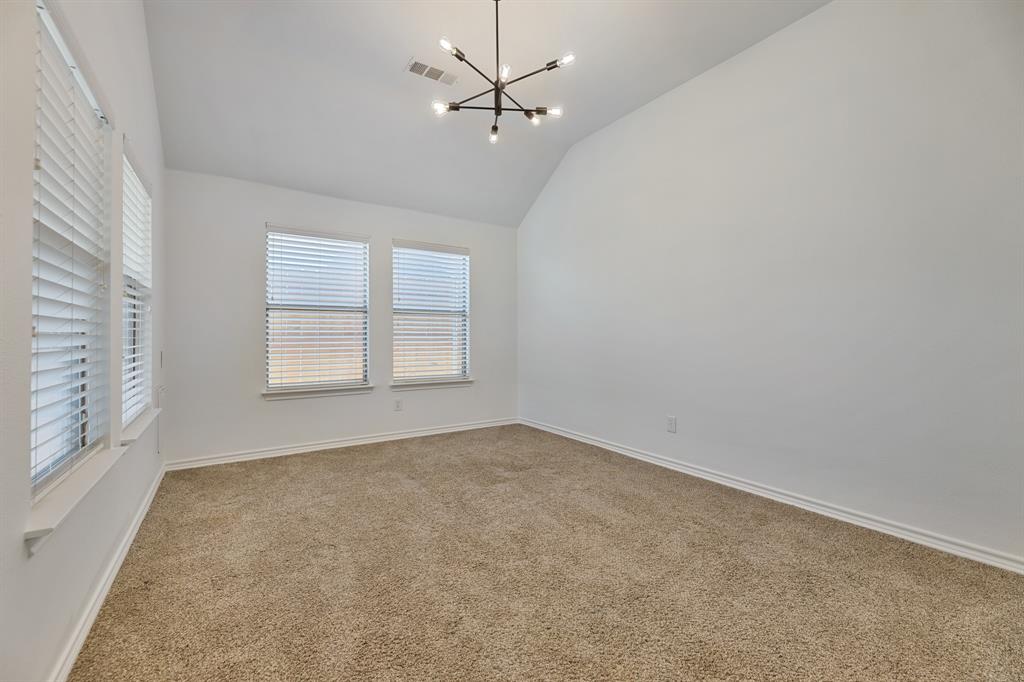 5129 Leeray Road Fort Worth, TX 76244 - Photo 4 of 39 an empty room with windows and fan