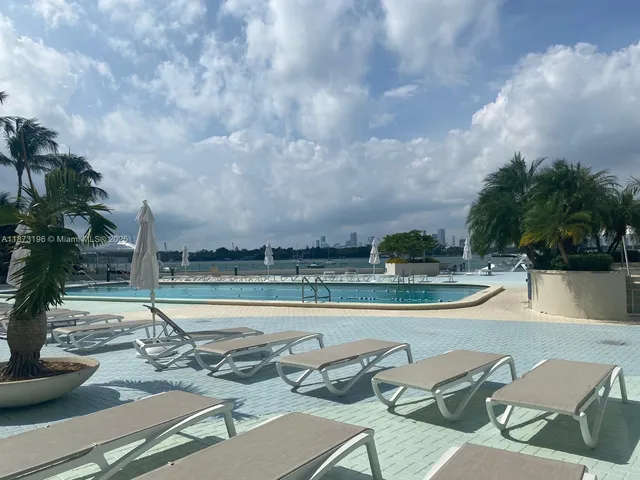 a view of a lake with couches and table and chairs