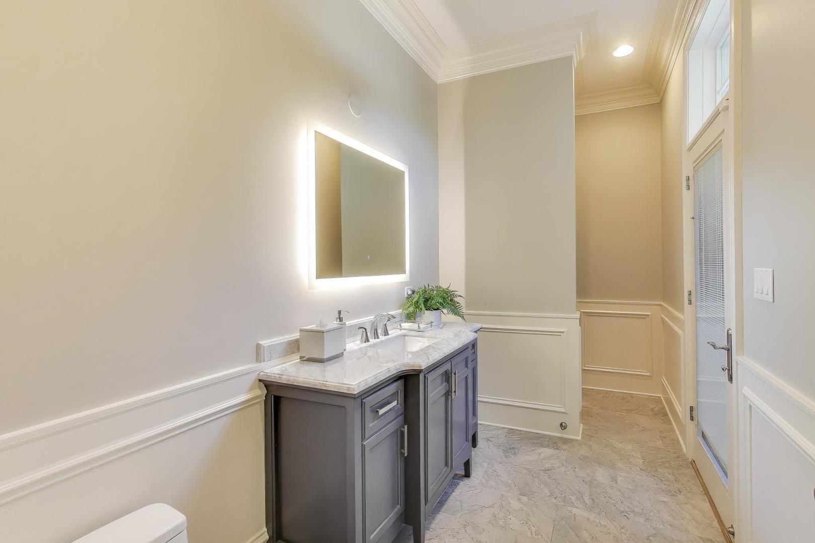 19 Meadowview Road Northfield, IL 60093 - Photo 20 of 65 a bathroom with a sink a toilet and a mirror
