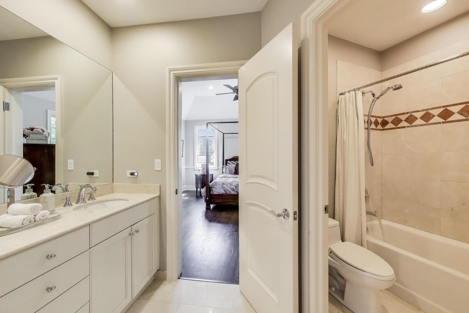 19 Meadowview Road Northfield, IL 60093 - Photo 35 of 65 a en suite bathroom with a sink a toilet and a large mirror