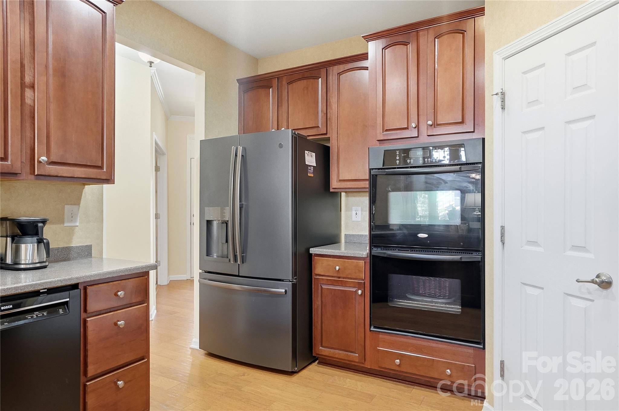 335 Garnet Court Fort Mill, SC 29708 - Photo 11 of 44 a kitchen with granite countertop stainless steel appliances and refrigerator