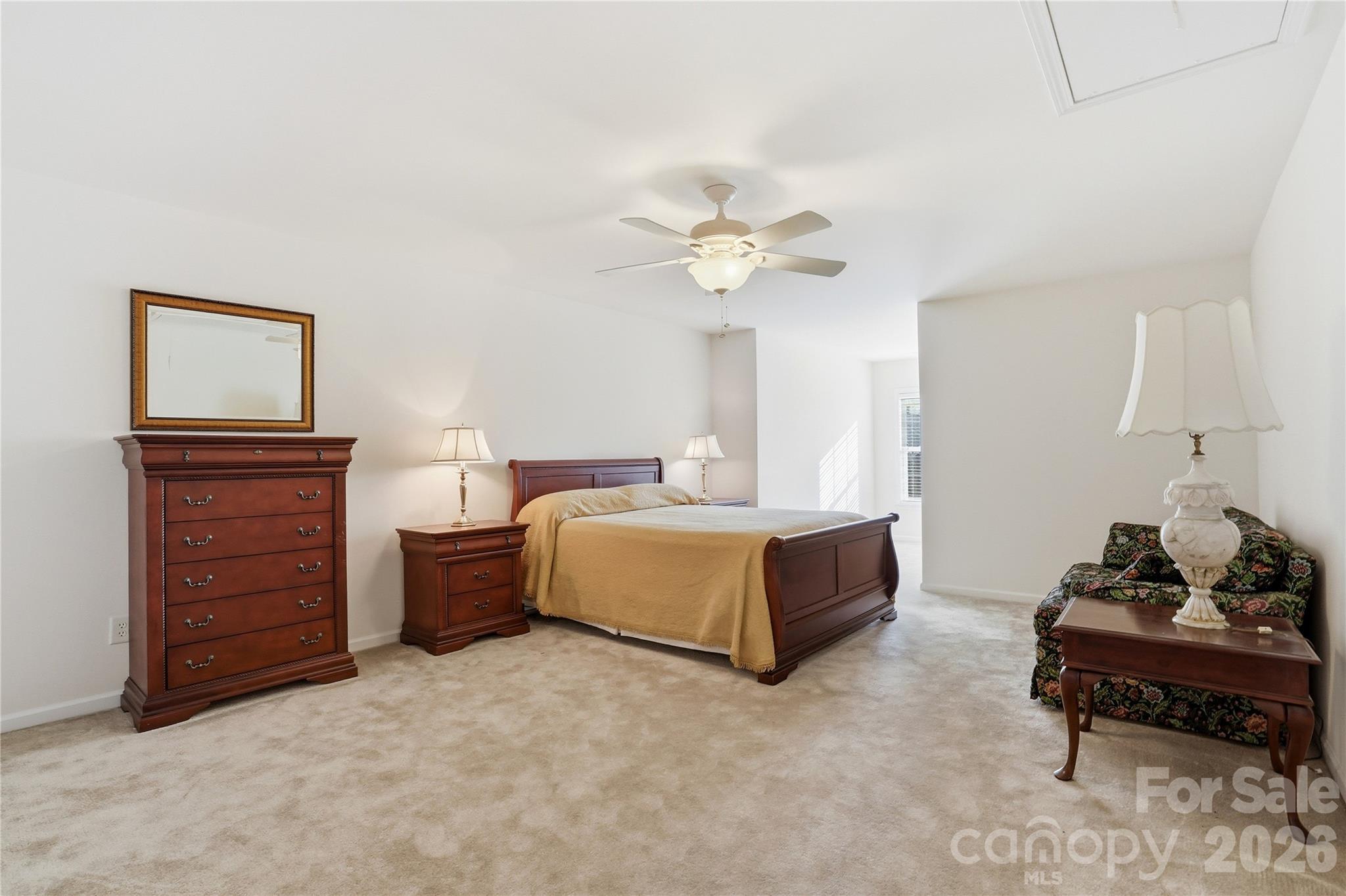 335 Garnet Court Fort Mill, SC 29708 - Photo 33 of 44 a spacious bedroom with a bed and a table