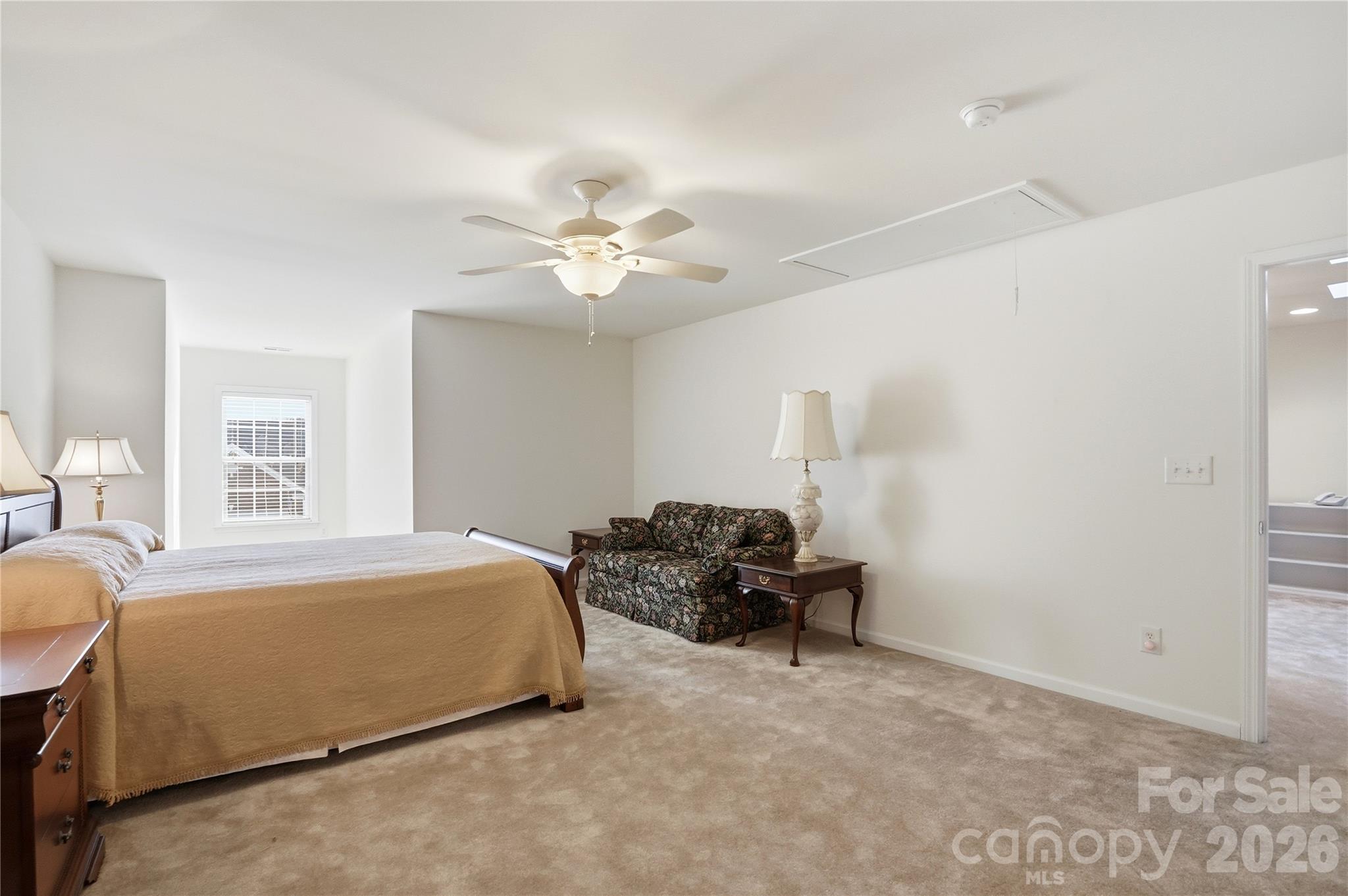 335 Garnet Court Fort Mill, SC 29708 - Photo 34 of 44 a bedroom with a bed and a chandelier