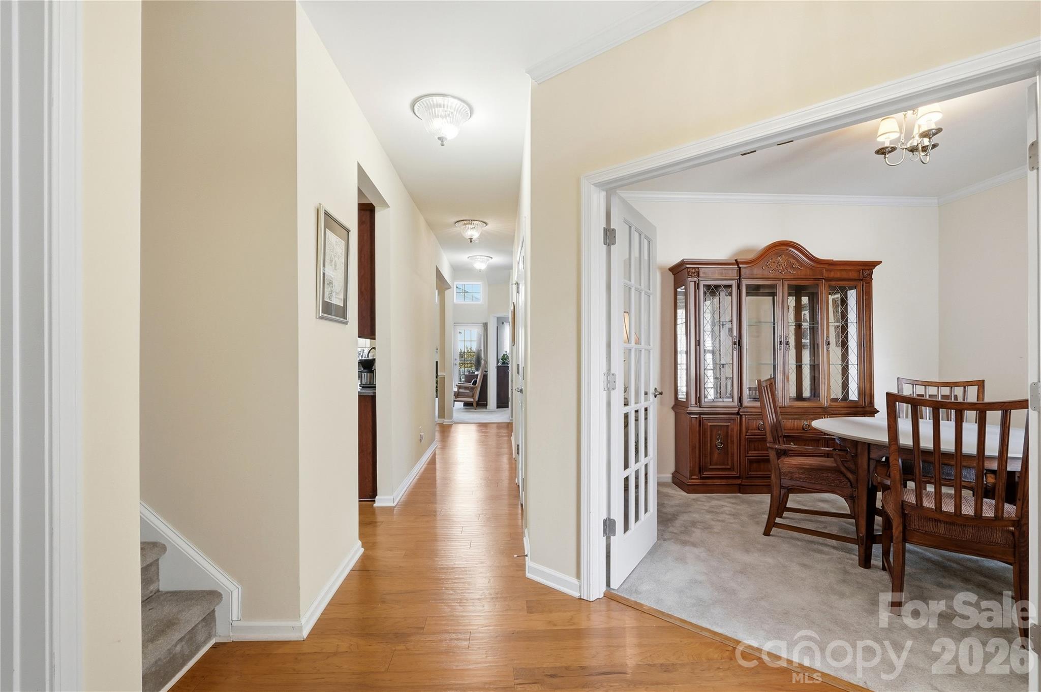 335 Garnet Court Fort Mill, SC 29708 - Photo 5 of 44 a view of a hallway with wooden floor a bedroom and windows