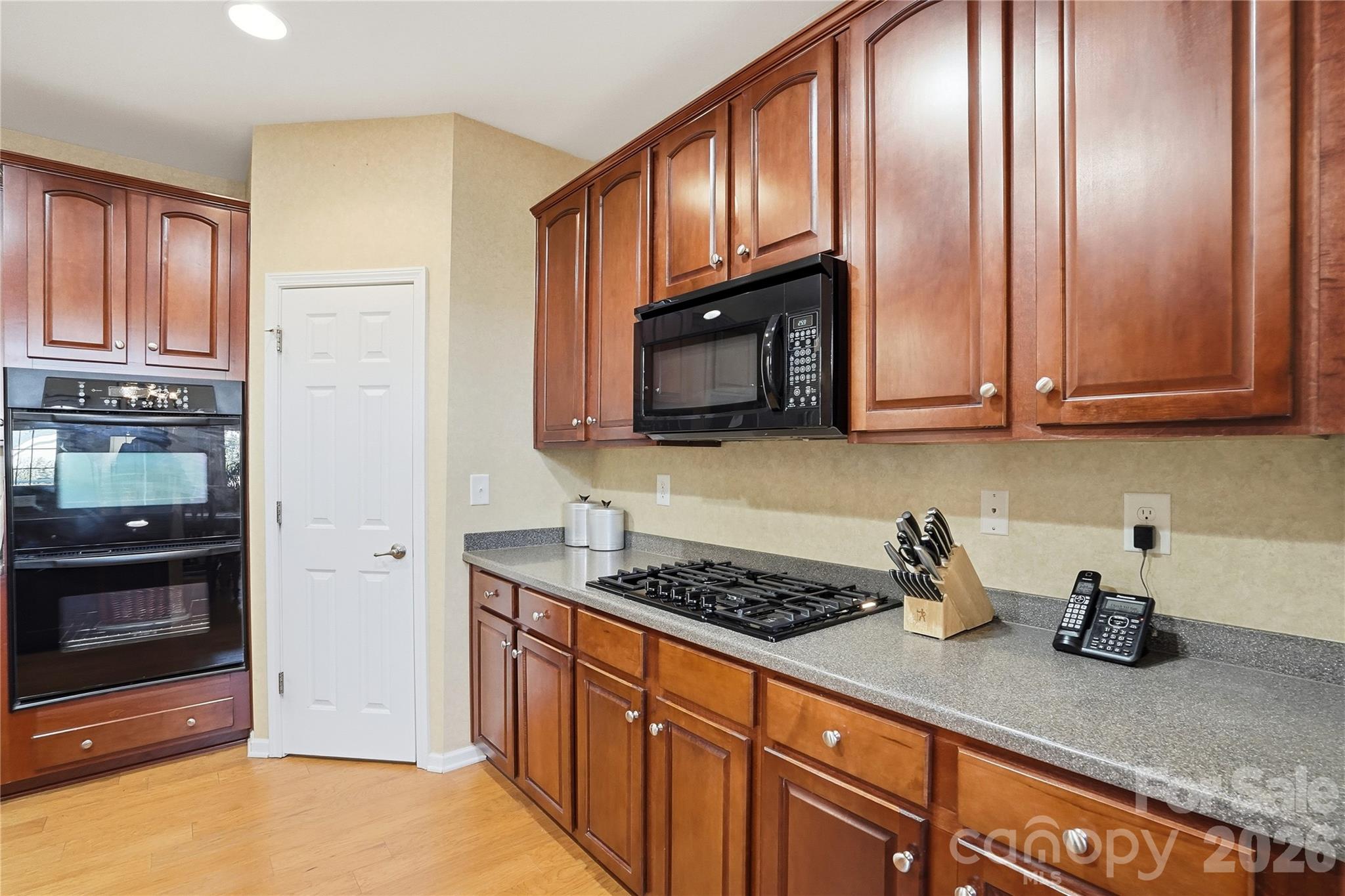 335 Garnet Court Fort Mill, SC 29708 - Photo 10 of 44 a kitchen with granite countertop stainless steel appliances a stove microwave and cabinets