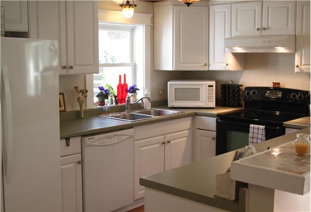 View of kitchen. Nice lighting!