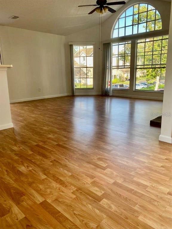 630 Steamboat Court, Unit 176 Altamonte Springs, FL 32714 - Photo 5 of 8 an empty room with wooden floor and windows