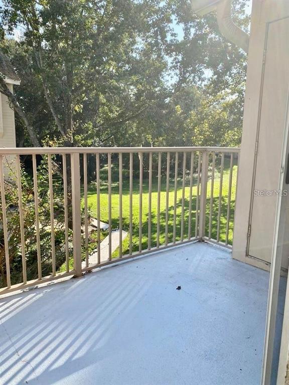 630 Steamboat Court, Unit 176 Altamonte Springs, FL 32714 - Photo 8 of 8 a view of a deck with a floor to ceiling window and wooden fence