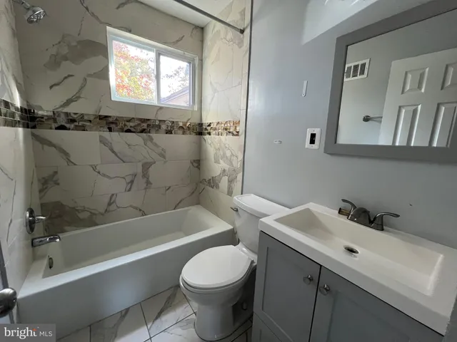 a bathroom with a sink toilet and bathtub