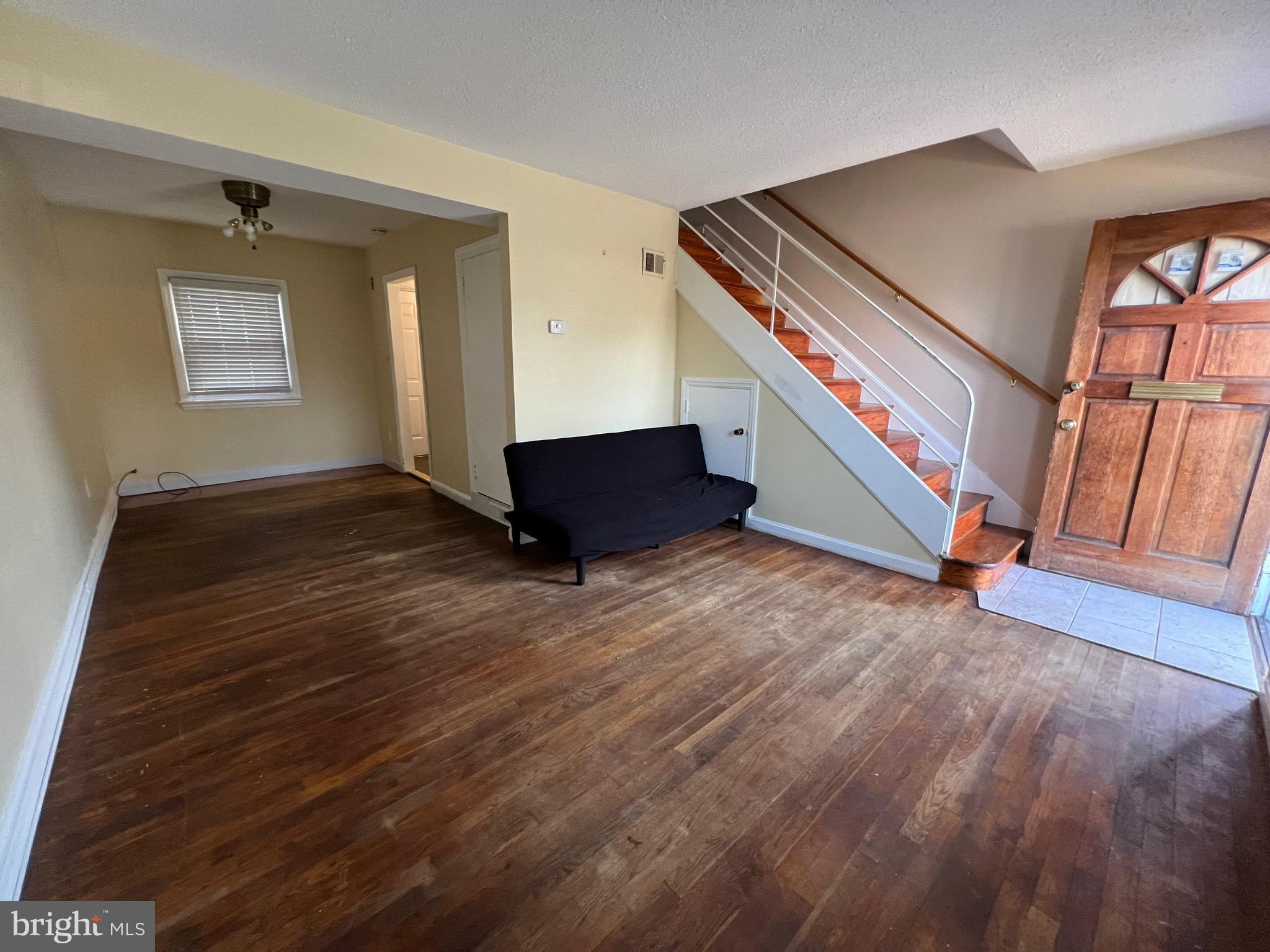 2581 Iverson Street Temple Hills, MD 20748 - Photo 7 of 13 a view of an empty room with wooden floor and a window