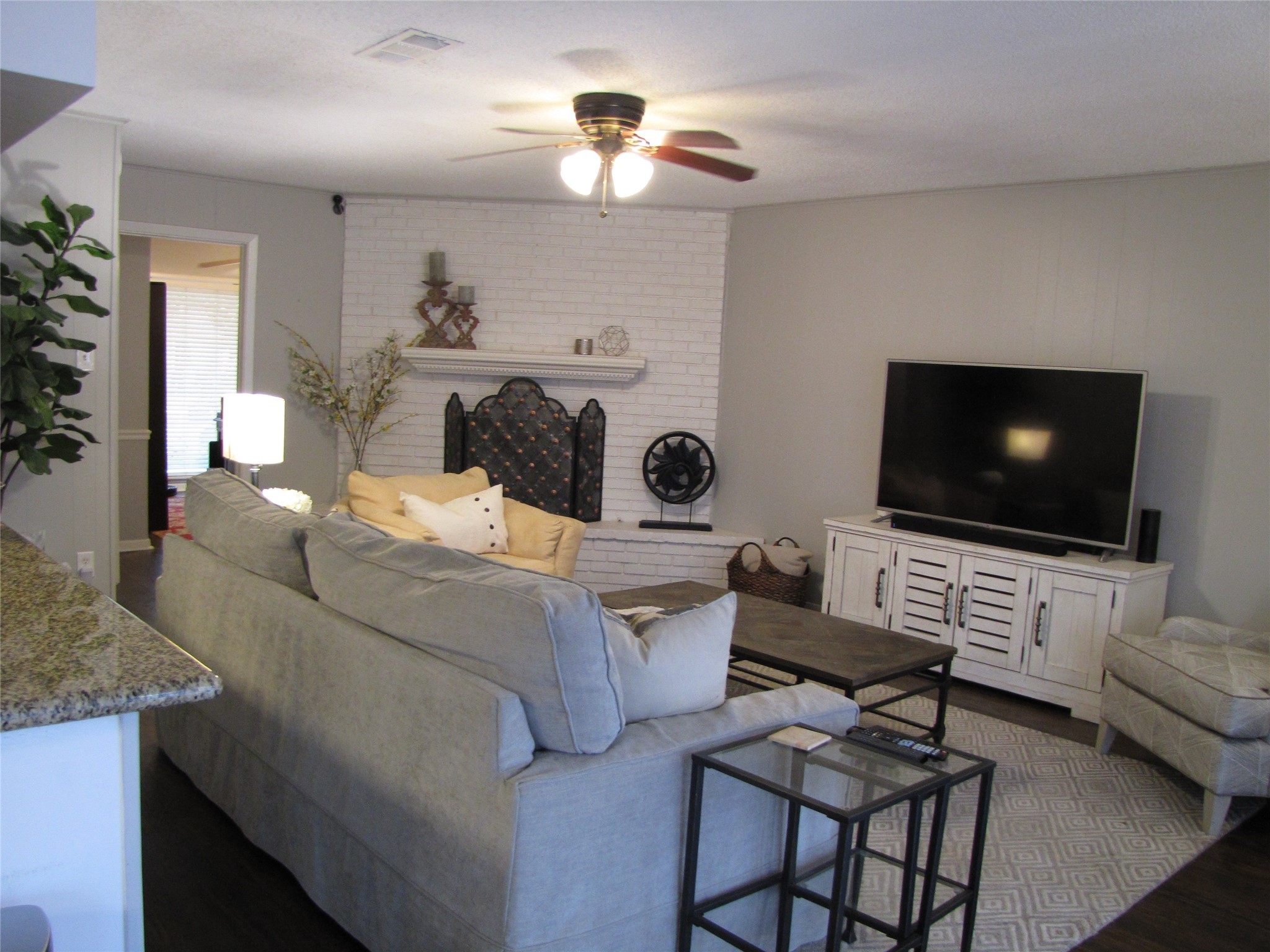 7902 Meadowcroft Drive Houston, TX 77063 - Photo 2 of 20 a living room with furniture and a flat screen tv