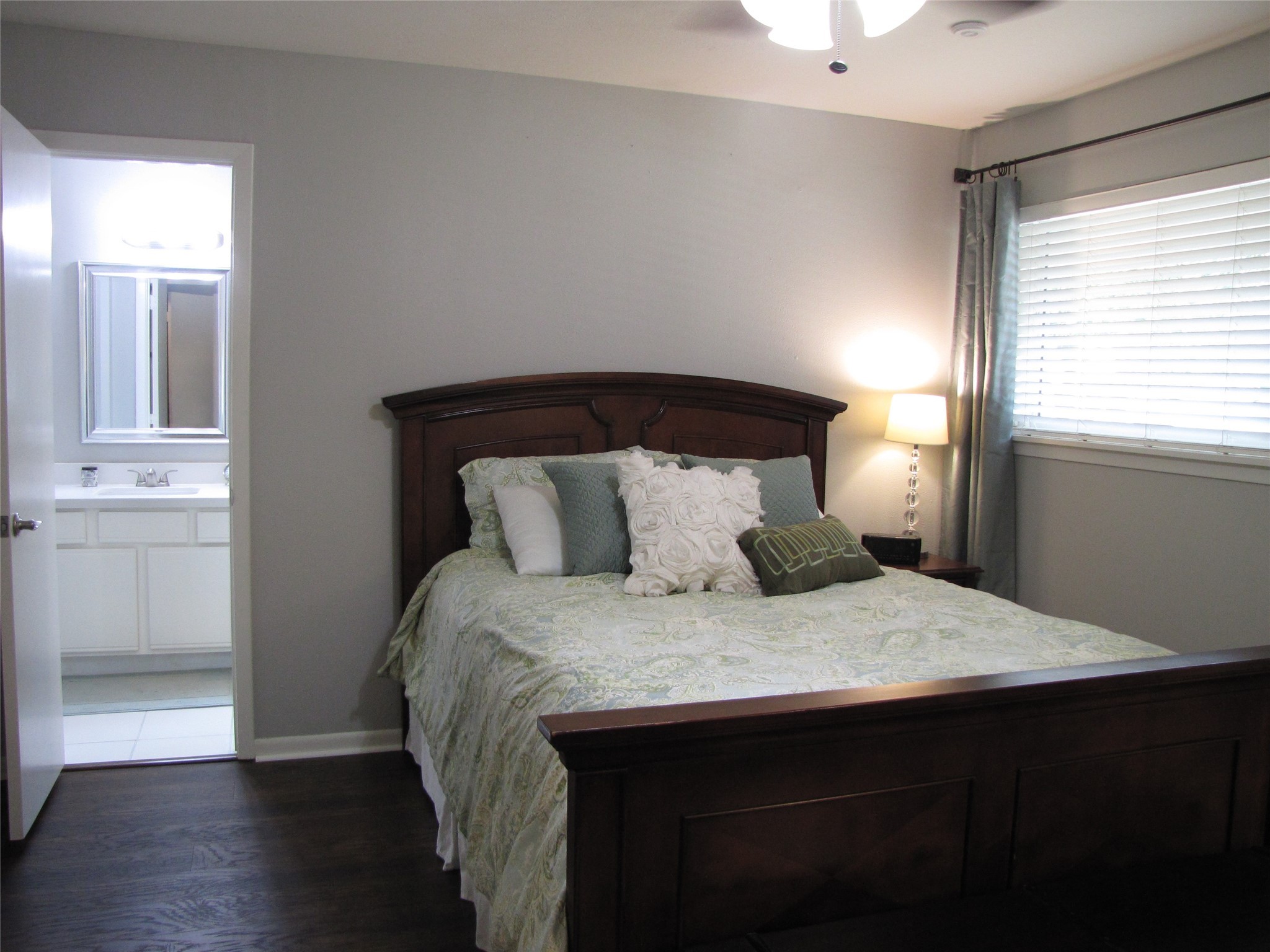 7902 Meadowcroft Drive Houston, TX 77063 - Photo 6 of 20 a bedroom with a bed and wooden floor