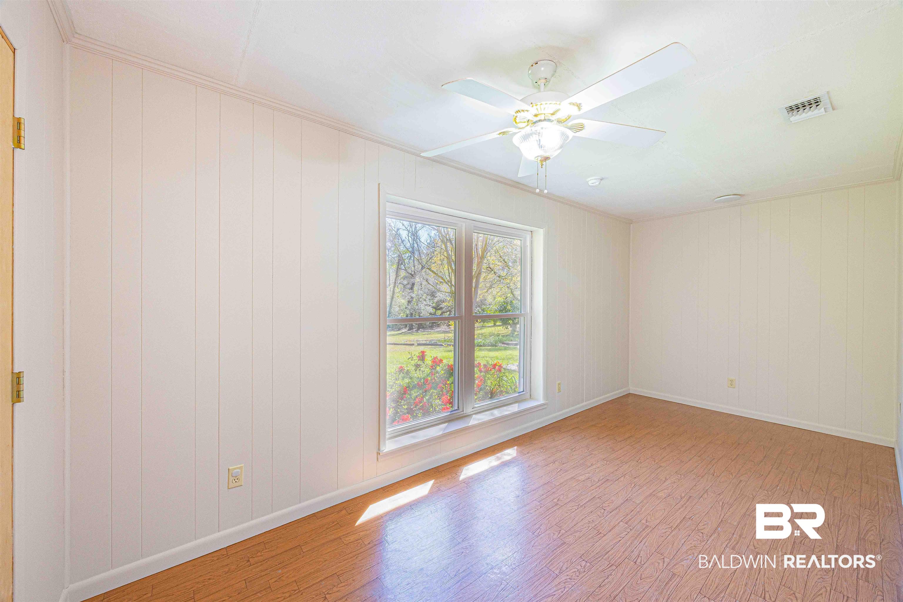 43101 Brown Road Bay Minette, AL 36507 - Photo 38 of 81 Bedroom with light wood finished floors, ceiling fan, and wooden walls