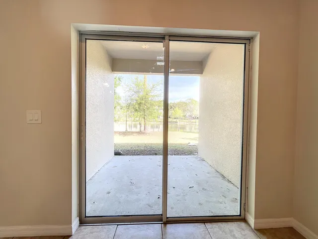 an empty room with wooden floor and outdoor view