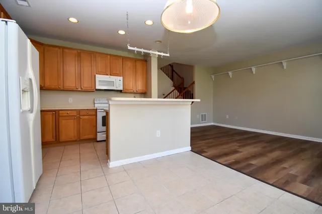 a kitchen with a sink window and wooden cabinets