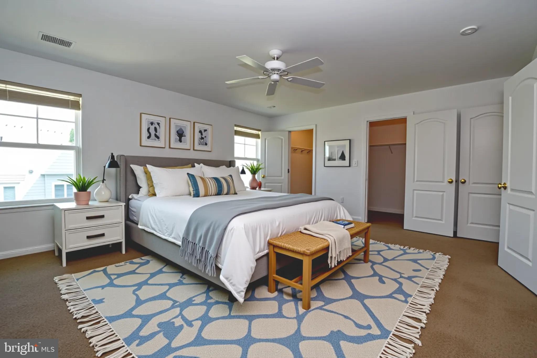 29549 Whitstone Lane, Unit 1305 Millsboro, DE 19966 - Photo 17 of 31 a bedroom with a bed and a table