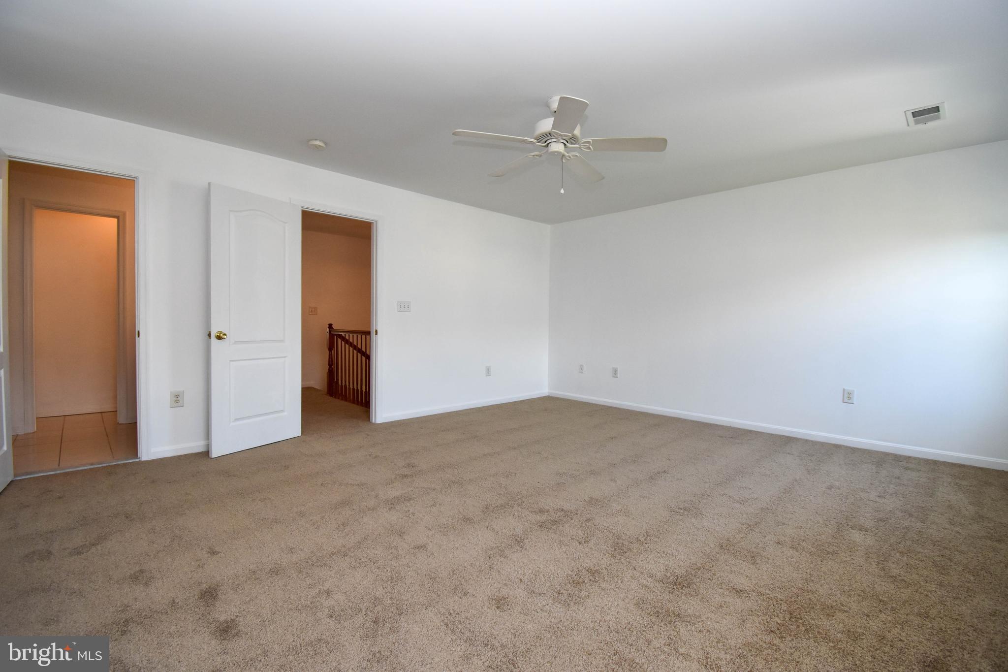 29549 Whitstone Lane, Unit 1305 Millsboro, DE 19966 - Photo 18 of 31 an empty room with a ceiling fan and a window