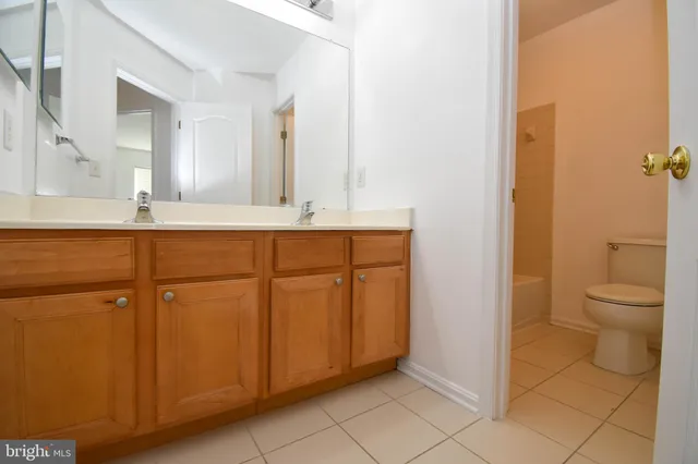 a spacious bathroom with a granite countertop sink and a mirror