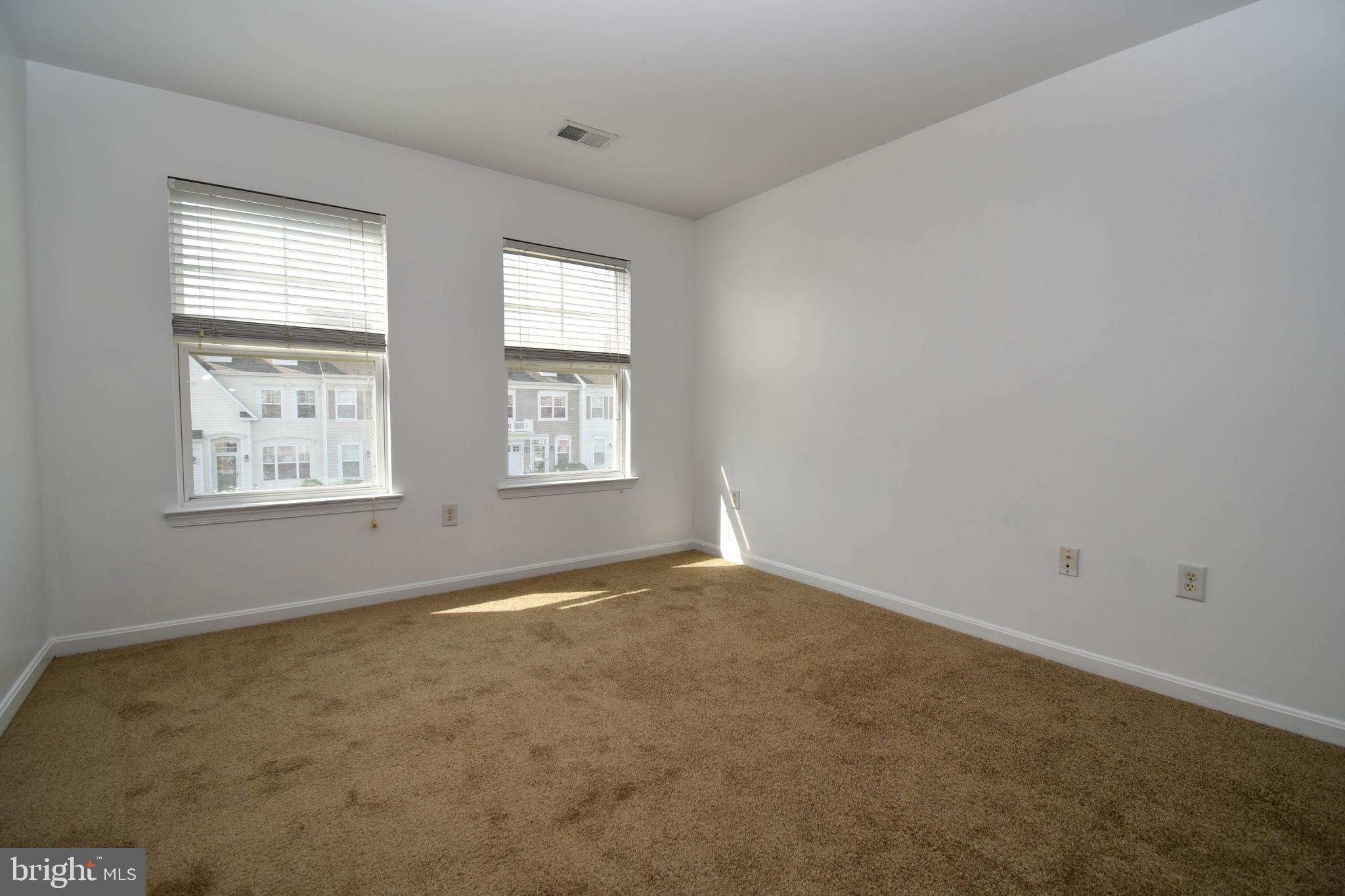 29549 Whitstone Lane, Unit 1305 Millsboro, DE 19966 - Photo 25 of 31 an empty room with windows