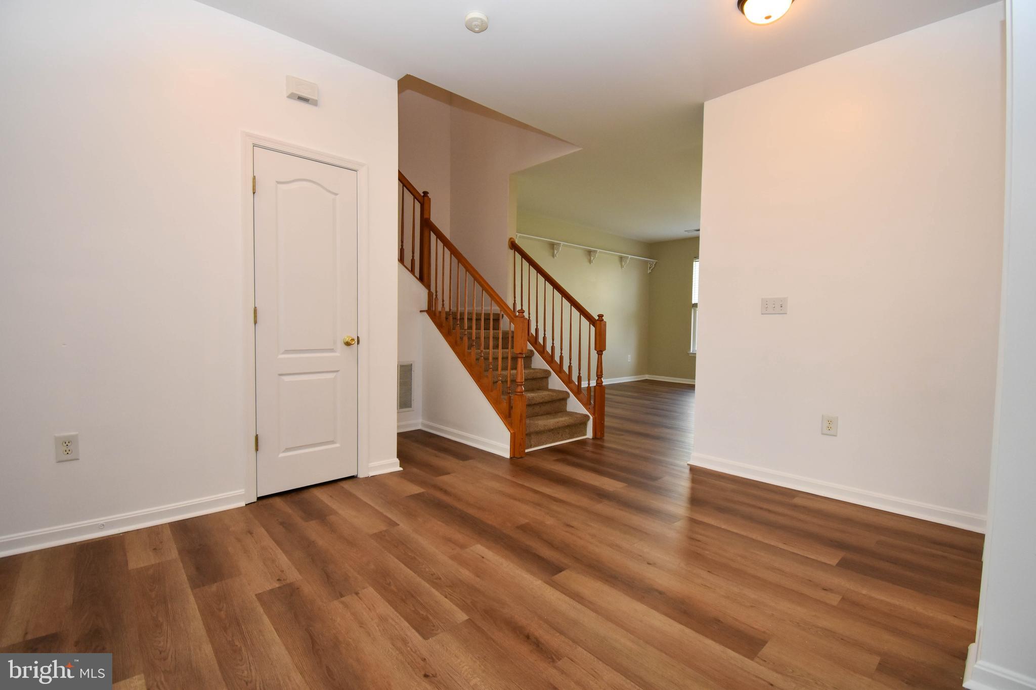 29549 Whitstone Lane, Unit 1305 Millsboro, DE 19966 - Photo 8 of 31 a view of an entryway with wooden floor