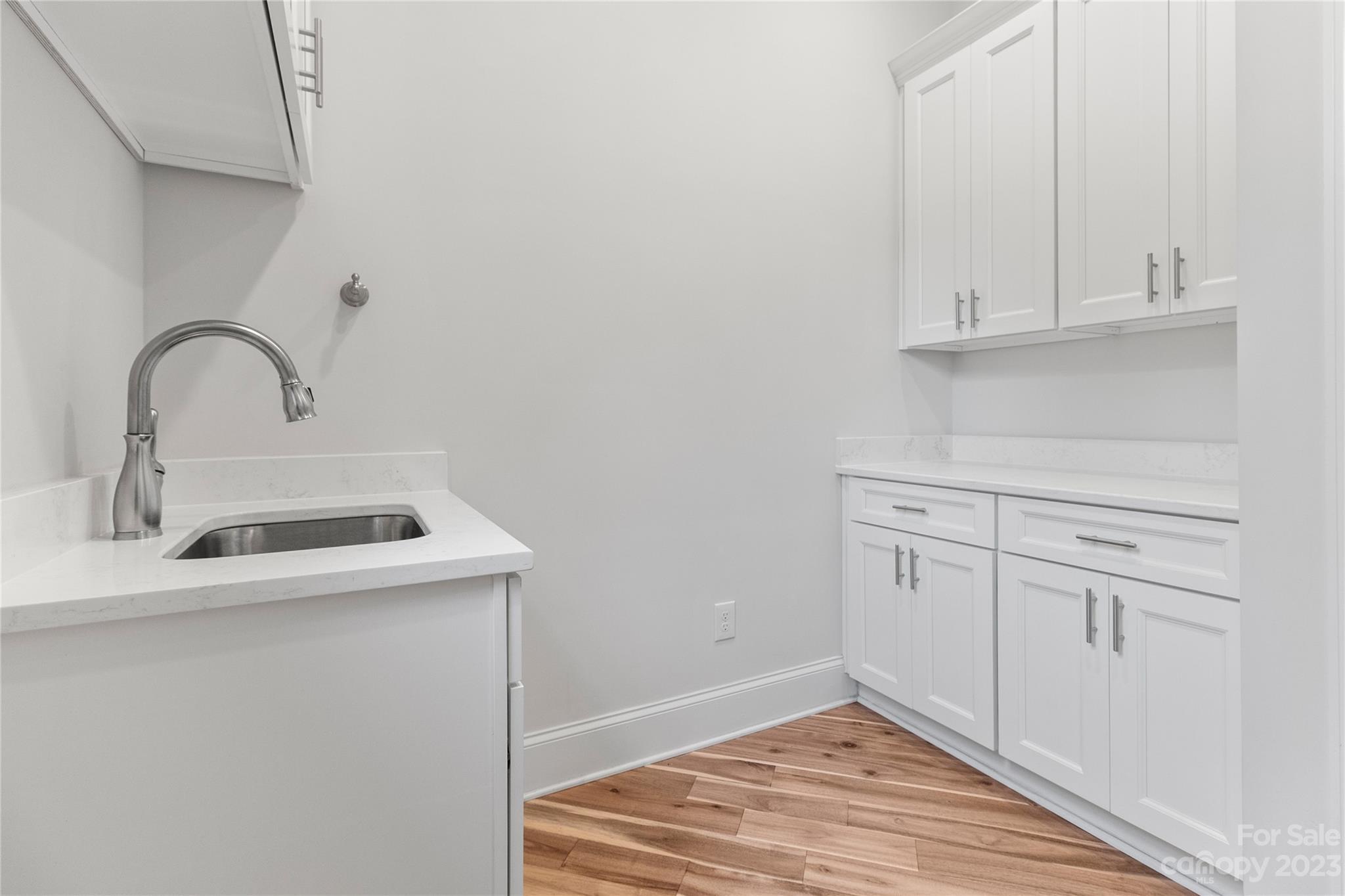 2500 Primm Road Denver, NC 28037 - Photo 11 of 46 a kitchen with white cabinets and sink