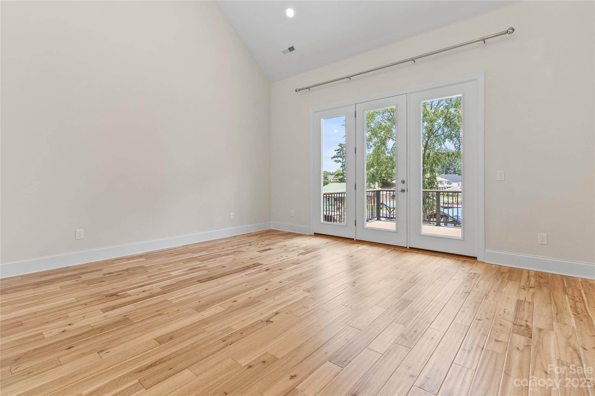 2500 Primm Road Denver, NC 28037 - Photo 12 of 46 a view of an empty room with wooden floor and a window