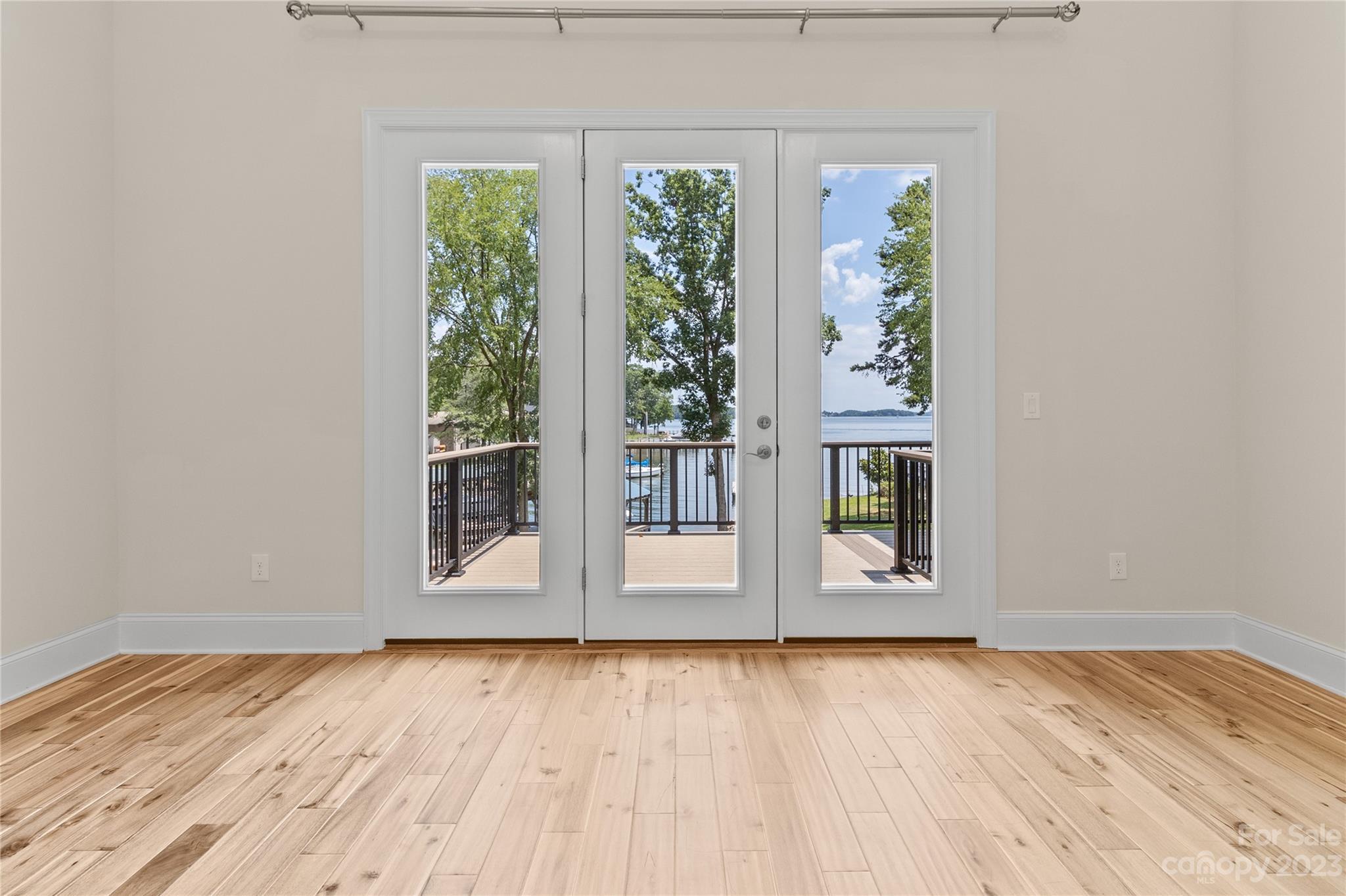2500 Primm Road Denver, NC 28037 - Photo 13 of 46 an empty room with wooden floor and windows