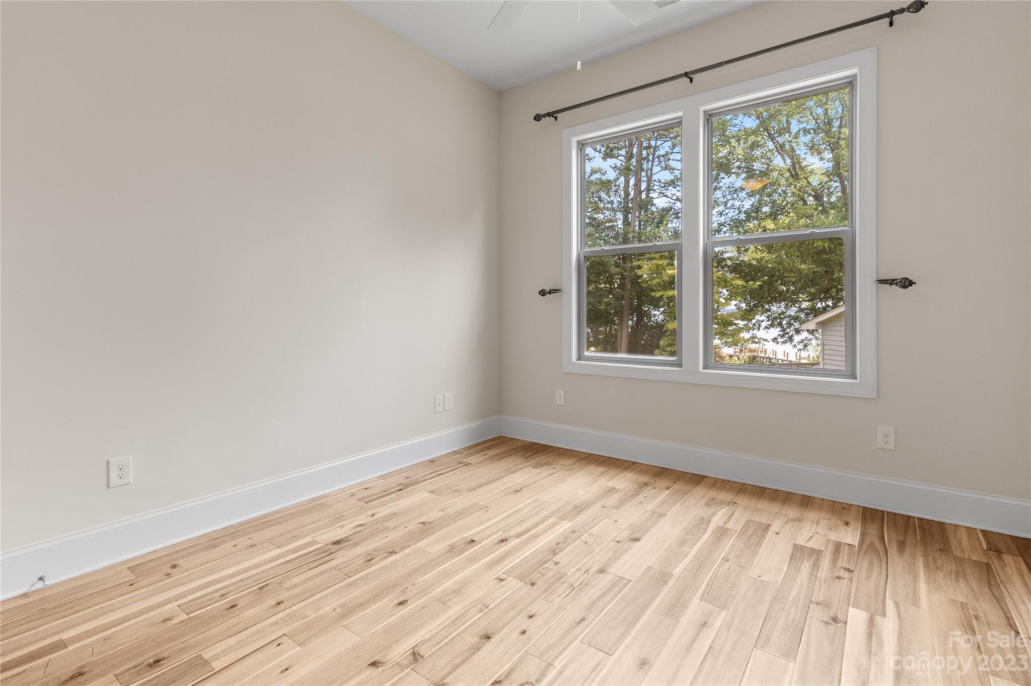 2500 Primm Road Denver, NC 28037 - Photo 18 of 46 a view of an empty room with wooden floor and a window