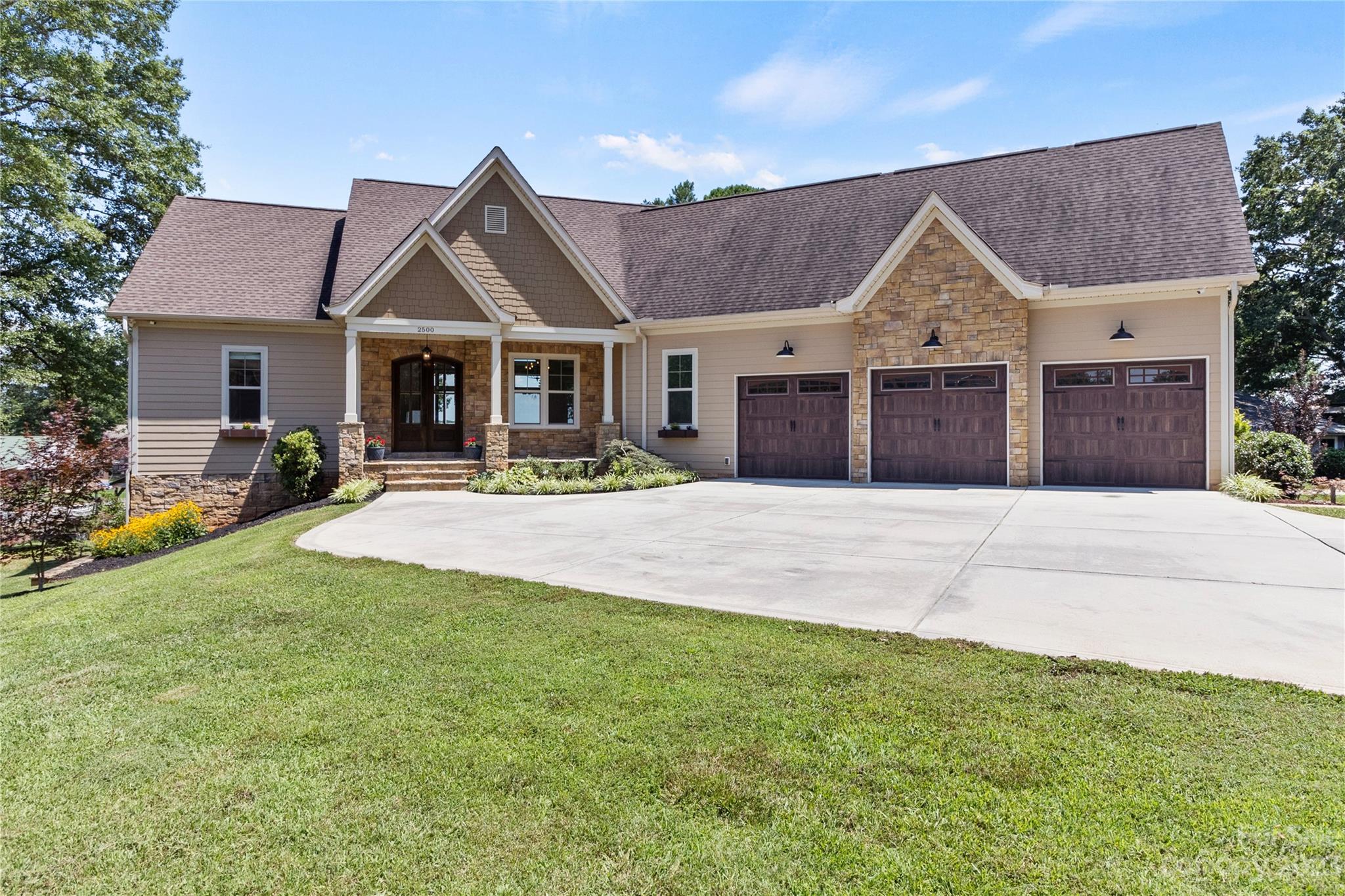 2500 Primm Road Denver, NC 28037 - Photo 2 of 46 a front view of a house with a yard and palm trees