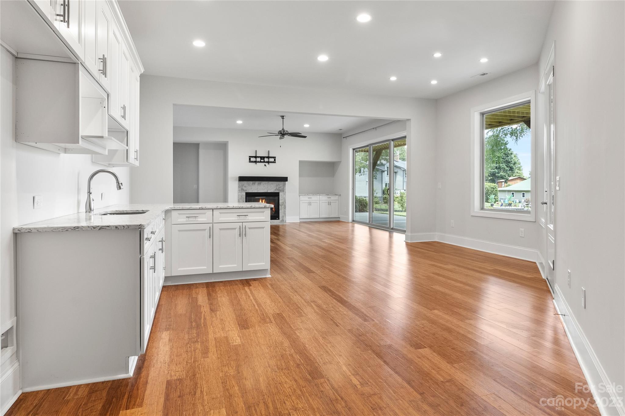 2500 Primm Road Denver, NC 28037 - Photo 25 of 46 a kitchen with granite countertop a stove a sink dishwasher and a microwave oven with wooden floor
