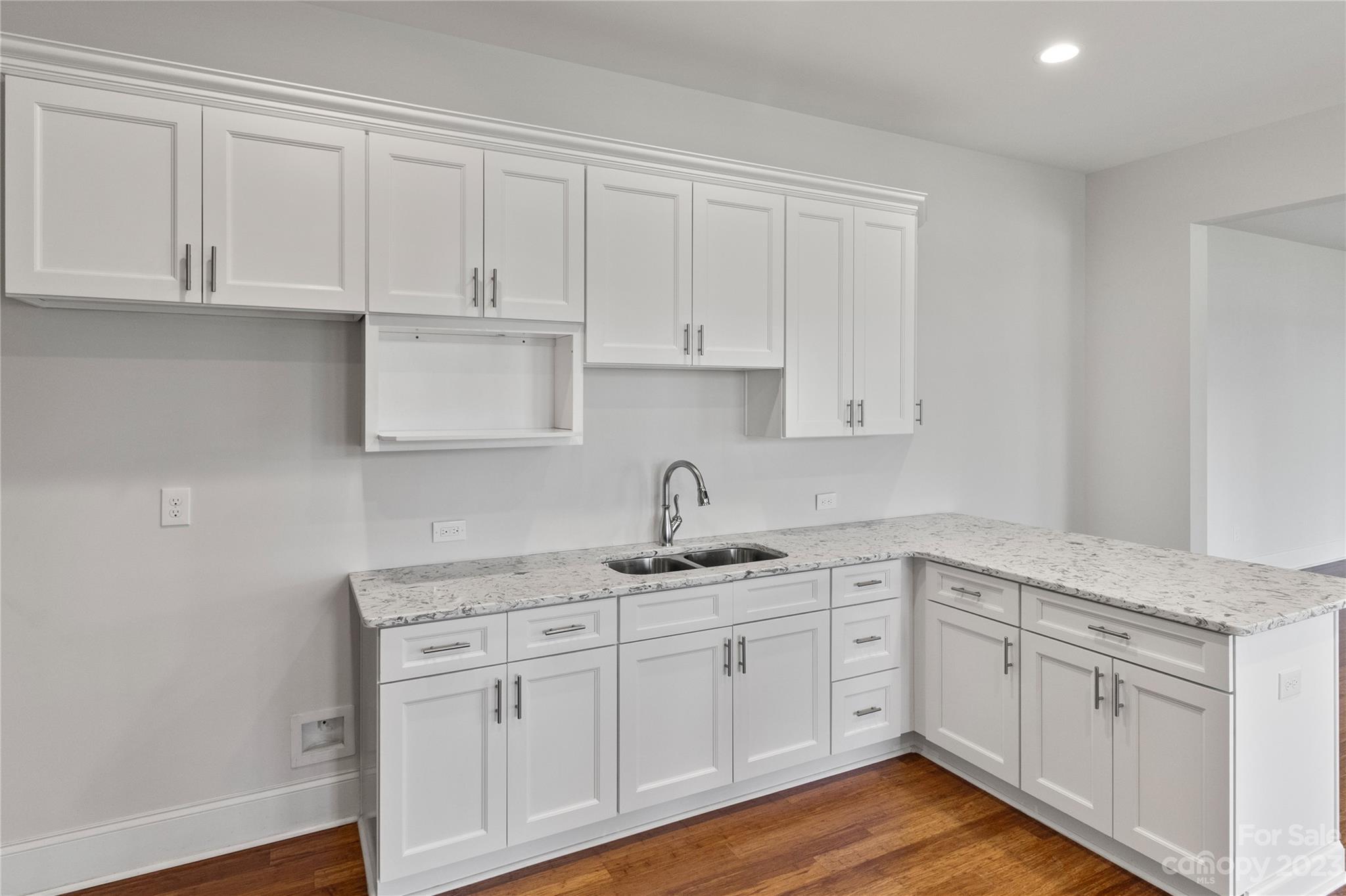 2500 Primm Road Denver, NC 28037 - Photo 26 of 46 a kitchen with white cabinets stainless steel appliances and sink