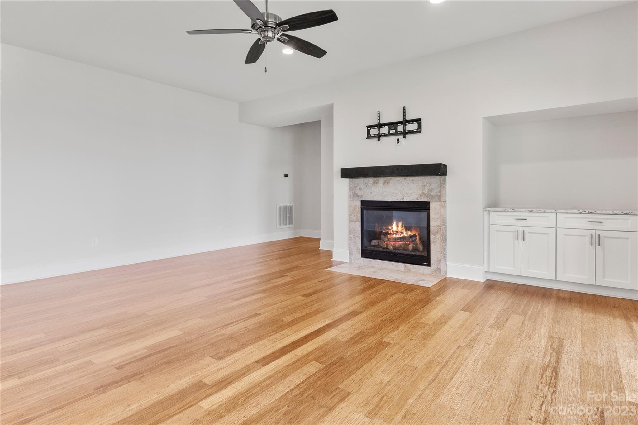 2500 Primm Road Denver, NC 28037 - Photo 27 of 46 a view of an empty room with wooden floor fireplace and a window