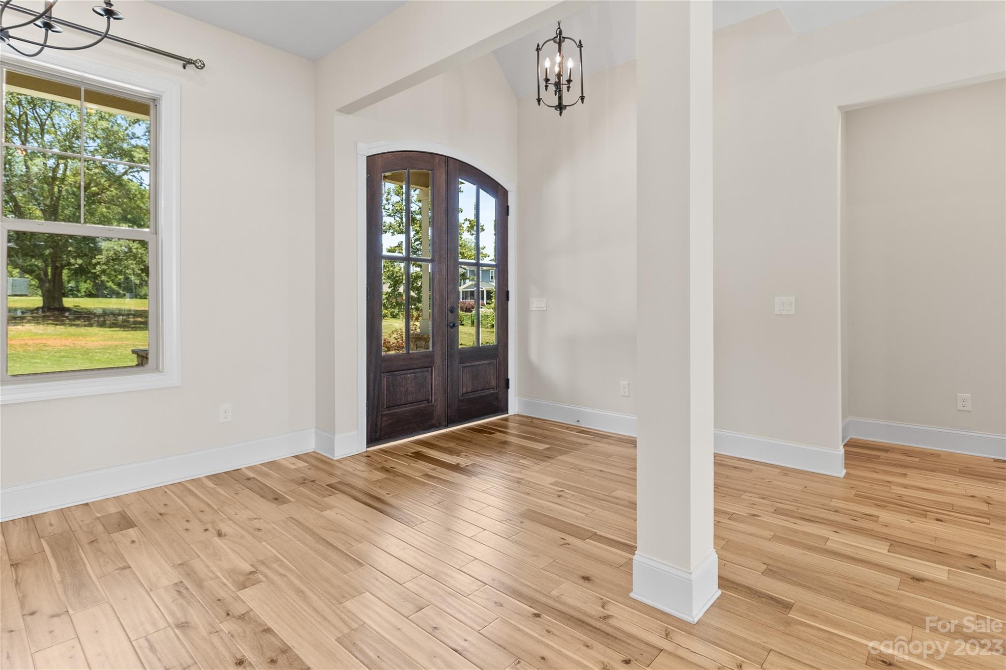 2500 Primm Road Denver, NC 28037 - Photo 5 of 46 a view of an empty room with wooden floor and a window