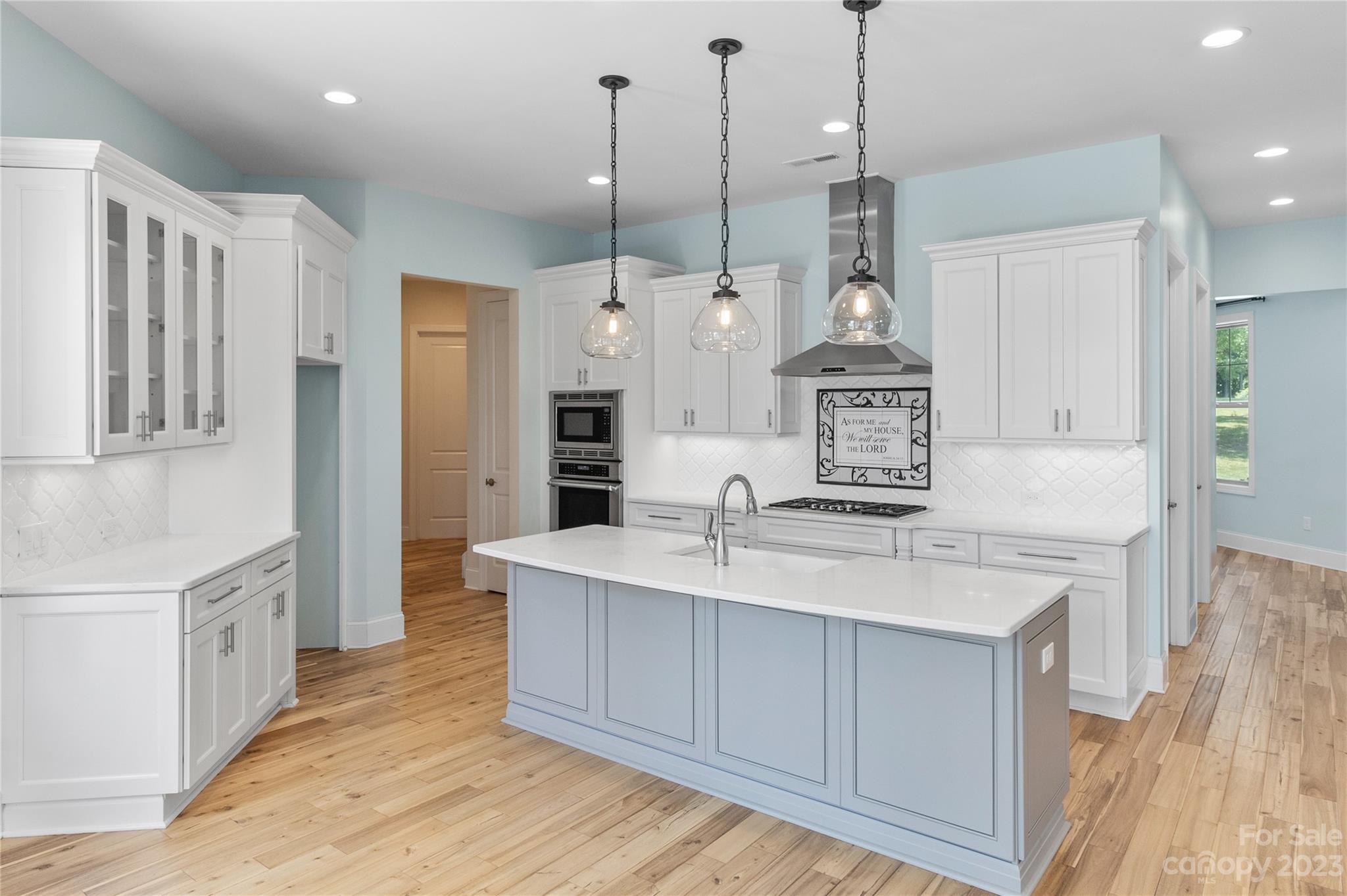 2500 Primm Road Denver, NC 28037 - Photo 9 of 46 a large kitchen with stainless steel appliances kitchen island granite countertop a sink a stove and a wooden floors