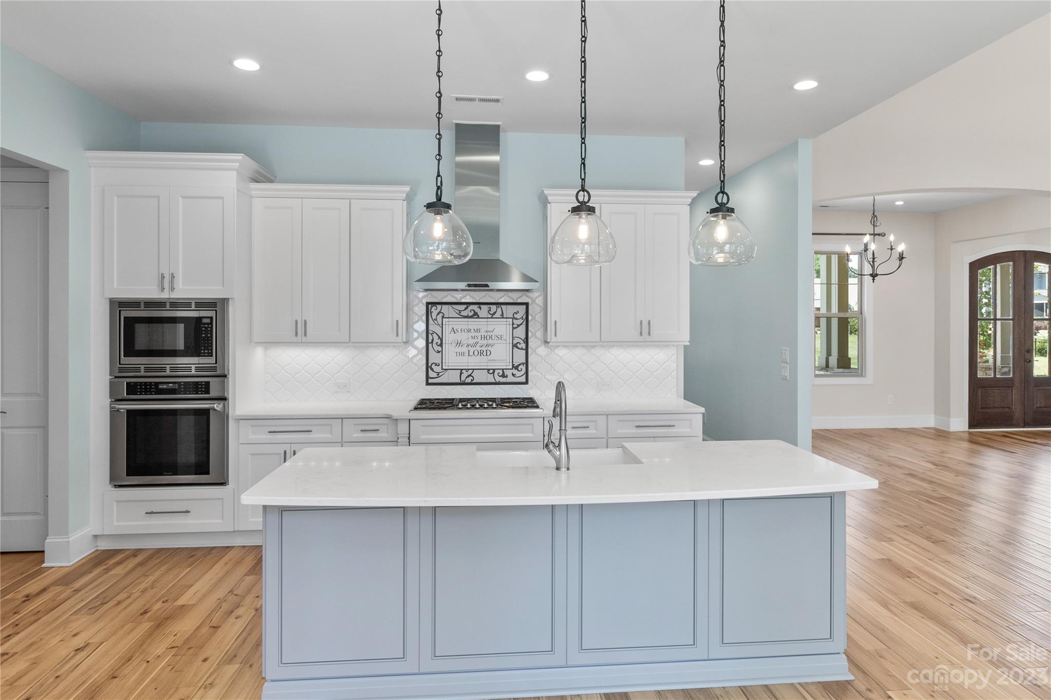 2500 Primm Road Denver, NC 28037 - Photo 10 of 46 a kitchen with kitchen island white cabinets and stainless steel appliances