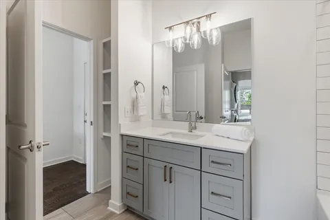 a bathroom with a sink a mirror and a bathtub