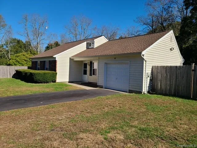 a view of a house with a yard and garage