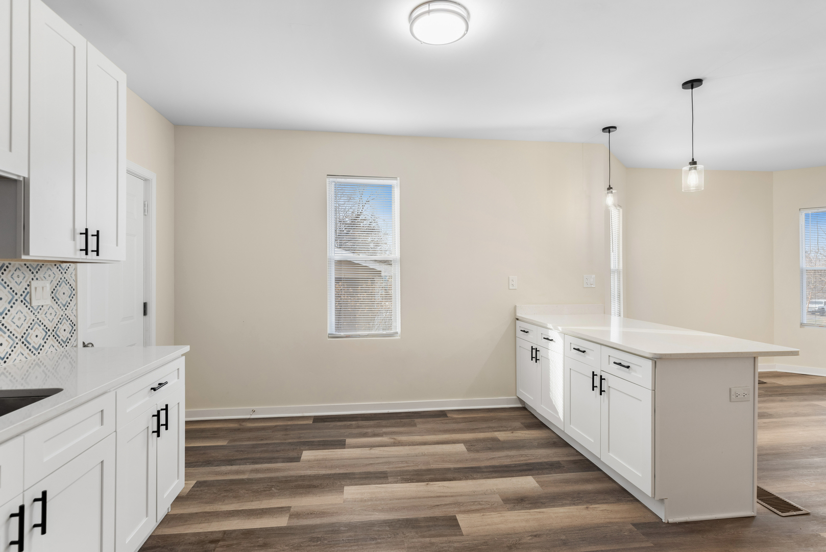 515 George Avenue, Unit 1 Waukegan, IL 60085 - Photo 6 of 15 a kitchen with granite countertop white cabinets and white appliances