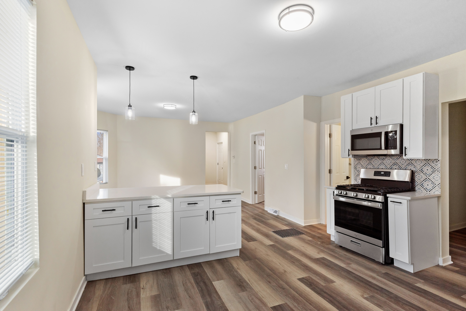 515 George Avenue, Unit 1 Waukegan, IL 60085 - Photo 10 of 15 a kitchen with a sink stainless steel appliances and cabinets