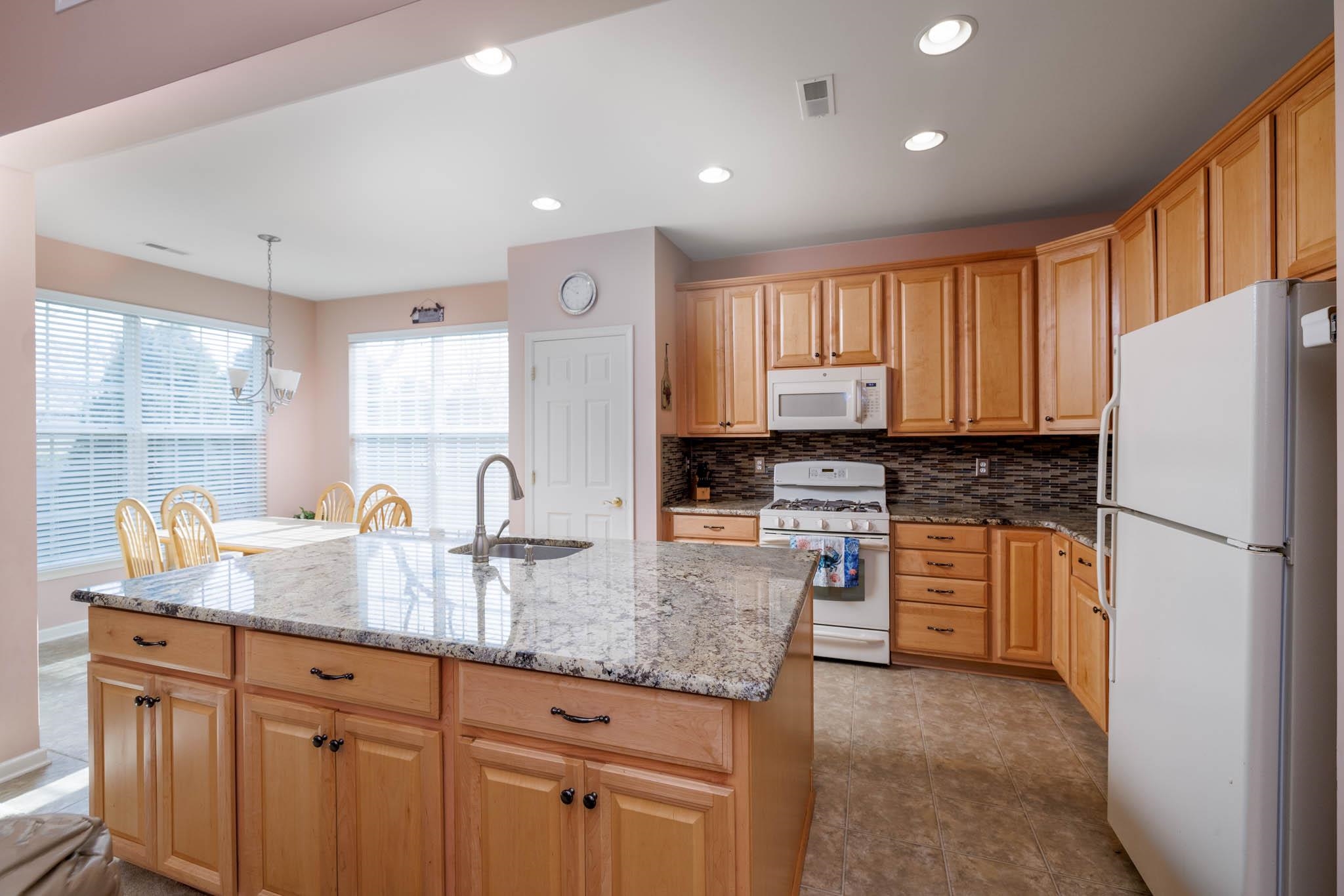118 Aberdeen Way Rio Grande, NJ 08242 - Photo 14 of 35 a kitchen with granite countertop white cabinets white appliances a granite counter tops and a window