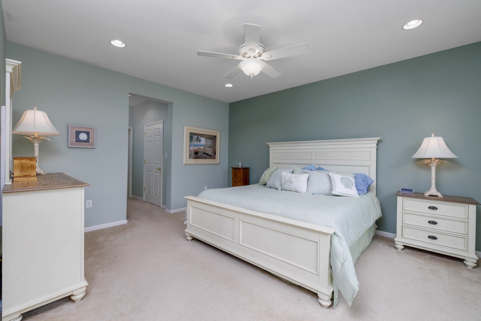 118 Aberdeen Way Rio Grande, NJ 08242 - Photo 18 of 35 a spacious bedroom with a bed and a chandelier