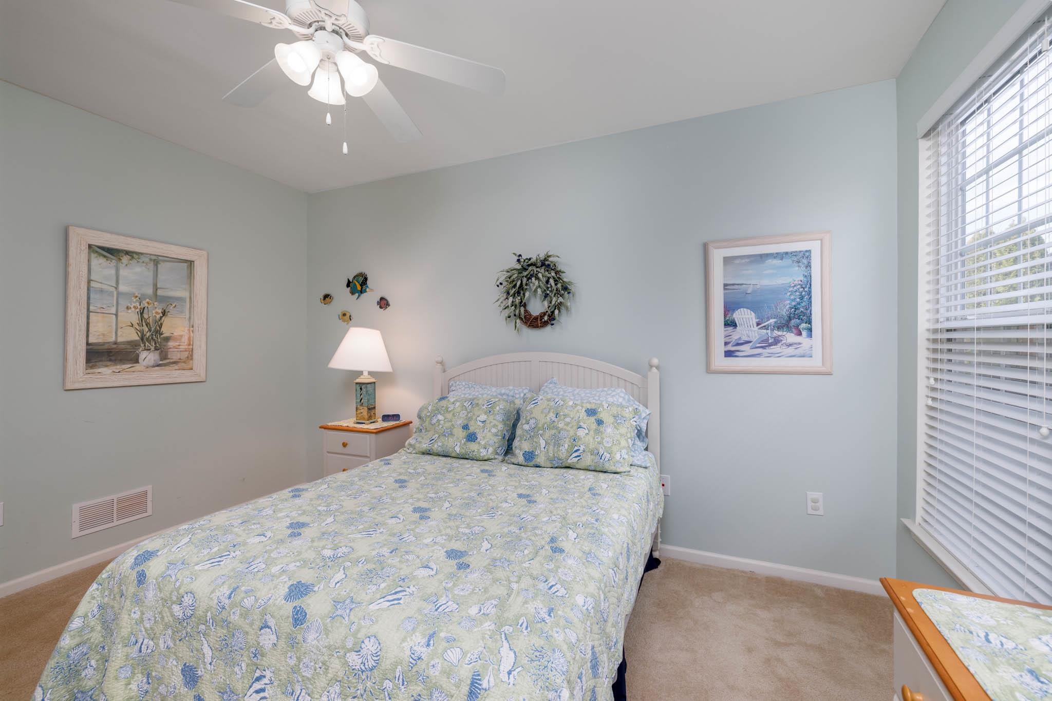 118 Aberdeen Way Rio Grande, NJ 08242 - Photo 22 of 35 a bedroom with a bed and a chandelier
